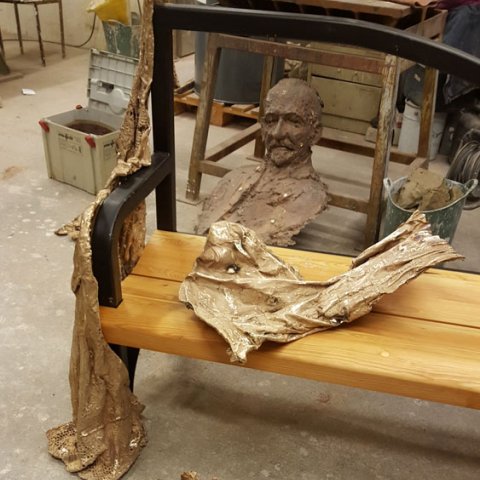making a bronze statue on a bench