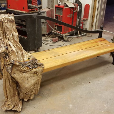 bronze statue on a bench